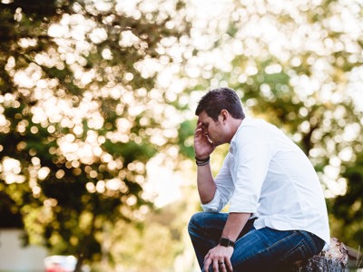 Man sitting with head in hand