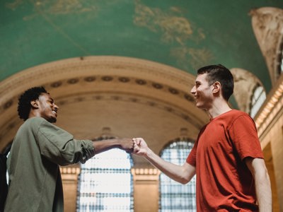 two men bumping fists together