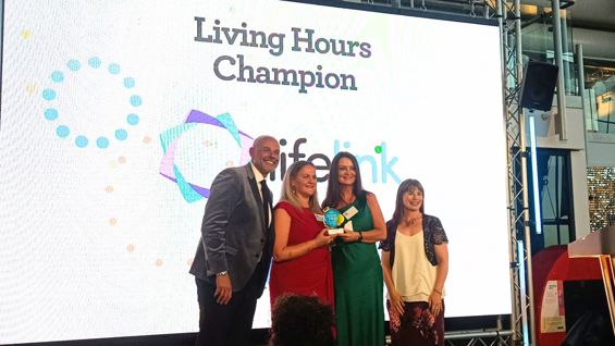 Lifelink staff collecting the Living Hours Champion trophy